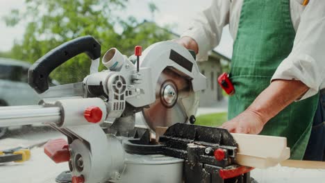 senior carpenter using circular saw