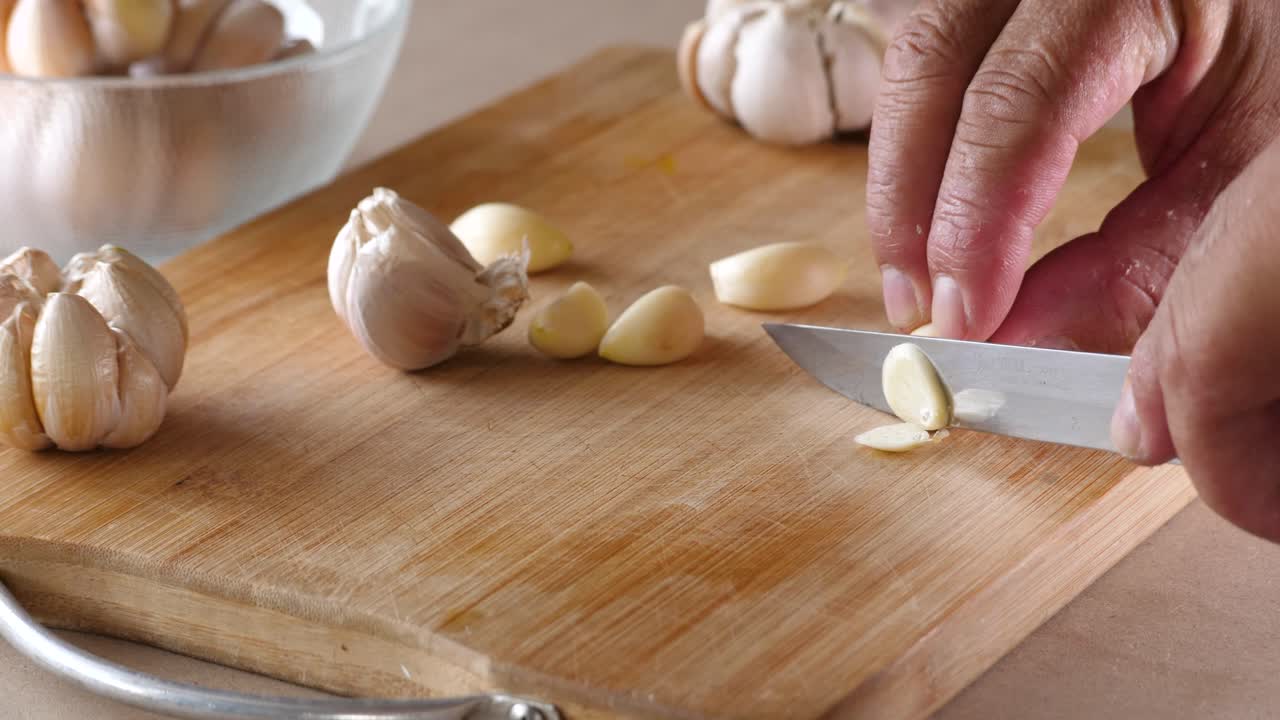 Slow motion of cutting fresh garlic