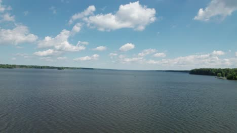 cinematic video of the running mosquito lake with fluffy clouds and a stunning blue sky.