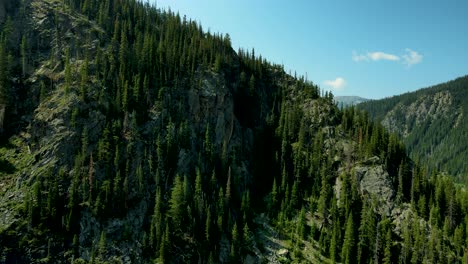 flying towards the rugged cliffs and granite peaks in the rocky mountains