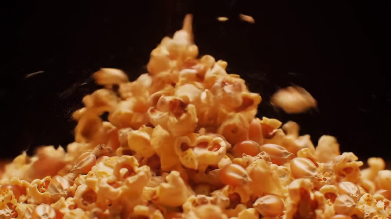 Deliciously Popped: A Close-Up Exploration of Golden, Fluffy Popcorn Piling Up Against a Dark Background, Perfect for Snack Time and Movie Nights