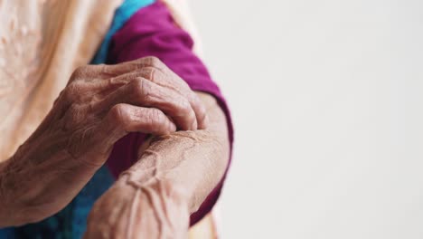 elderly woman itching her arm