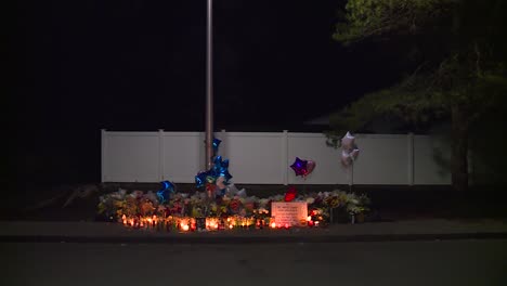 CANDLES-LIGHT-UP-A-MEMORIAL-AT-NIGHT