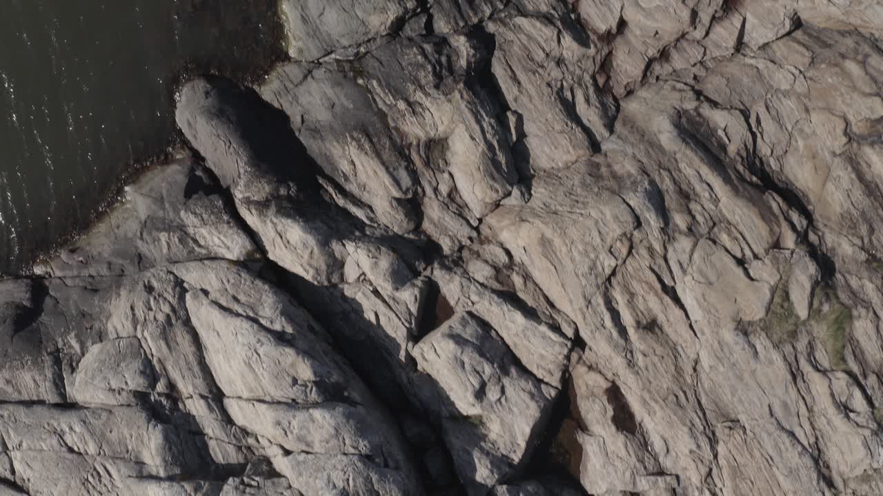 Drone footage of coastal rocks in water in Ar&ouml;d on the Swedish west coast