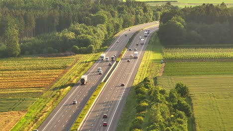 aerial view of highway traffic through lush countryside