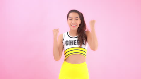 a flirty young cheerleader reacts with excitement to outside forces