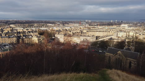 Edinburgh-skyline-view-from-Calton-Hill-panning-left-to-right-from-Leith-Walk-over-towards-Leith-on-a-cloudy-day,-Edinburgh,-Lothian,-UK