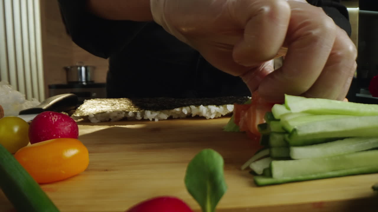 Hands Preparing Fresh Sushi Rolls with Salmon and Avocado