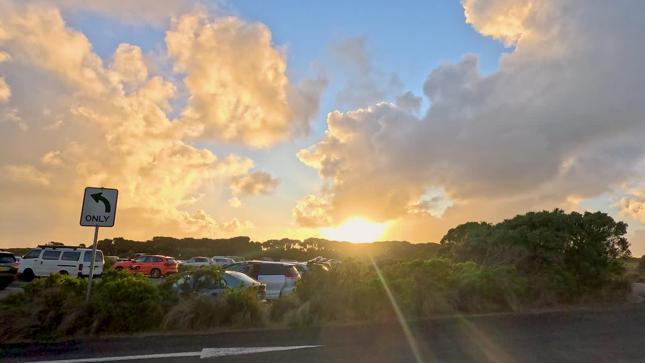 A serene sunset view over a parking lot on the Great Ocean Road, capturing vibrant skies and tranquil surroundings