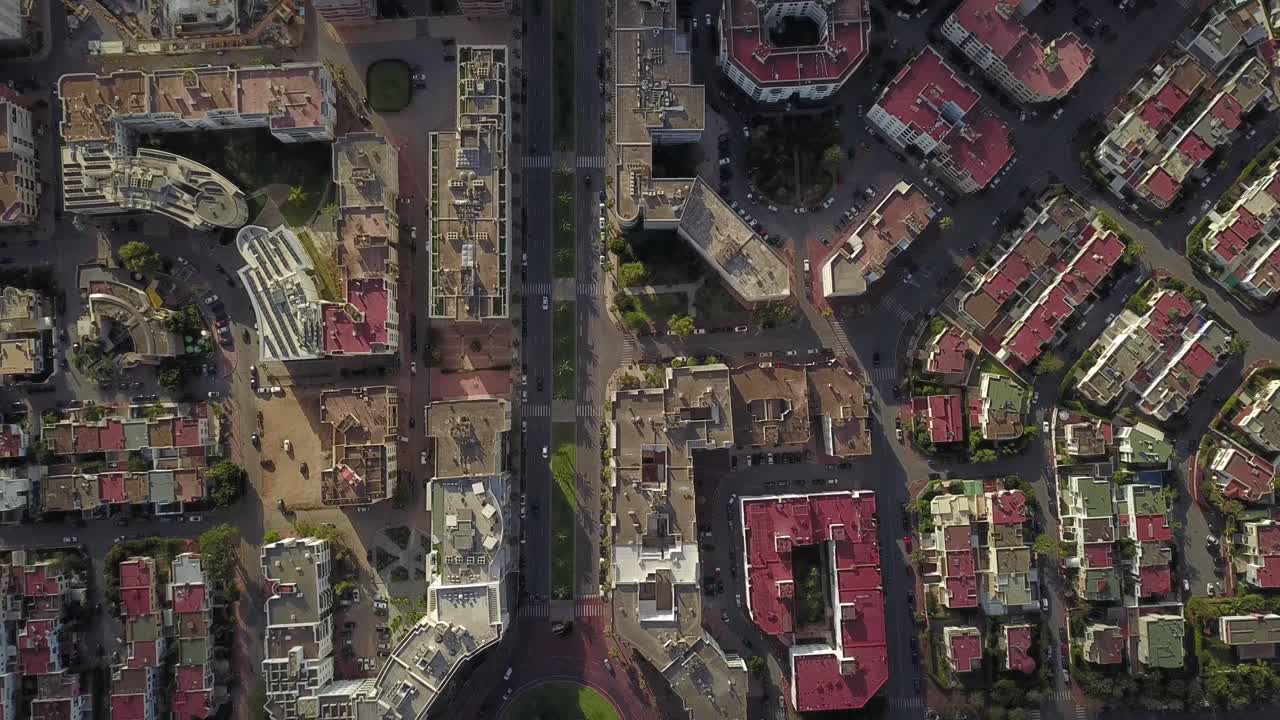 Top-down aerial drone shot showcasing the symmetrical urban planning of Hay Riad. Features luxury residential buildings, green courtyards, and organized street networks in Morocco's capital