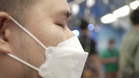 POV-to-a-man-wearing-mask-while-ridding-subway-public-transportation-in-Bangkok