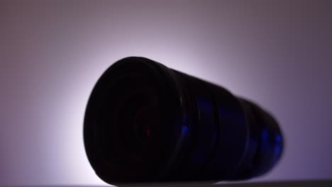 close-up of a camera lens with purple and blue lighting