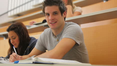 student looking up from lecture and smiling