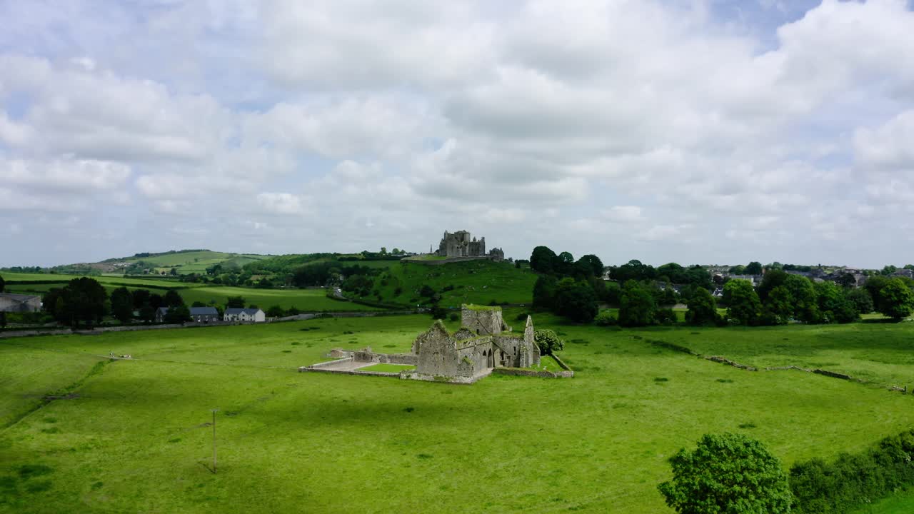Aerial view pulling away from a worn down castle in Europe.