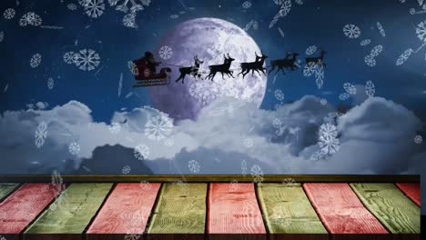 animación de copos de nieve cayendo sobre santa claus en trineo tirado por renos contra el cielo nocturno