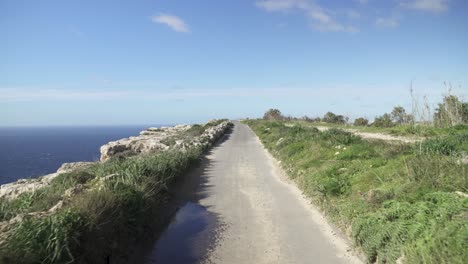 road leading towards dingli cliffs on green grassland