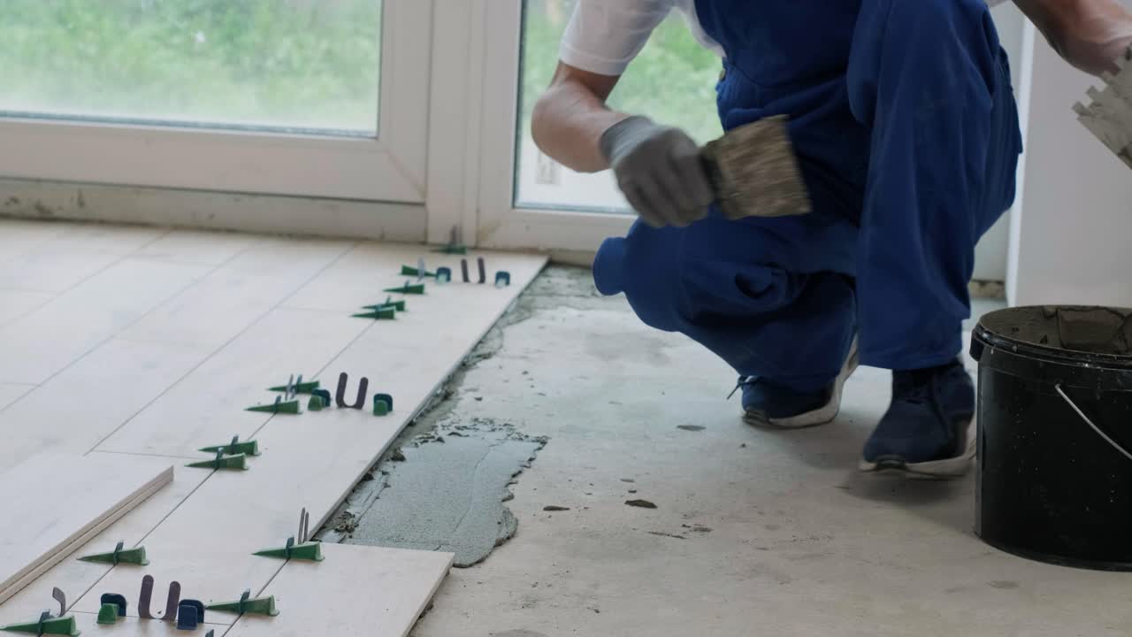 Installing ceramic floor tiles - measuring and cutting the pieces. Construction, renovation, repair apartment. Cuts tile. Tile cutting
