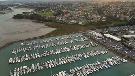 the camera over the glittering water, revealing the intricate details of the marina, from the docks to the boats