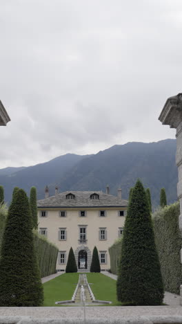 grand villa with formal garden and mountain backdrop