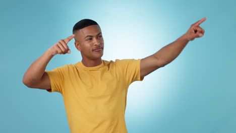 pointing, smile and young man in studio