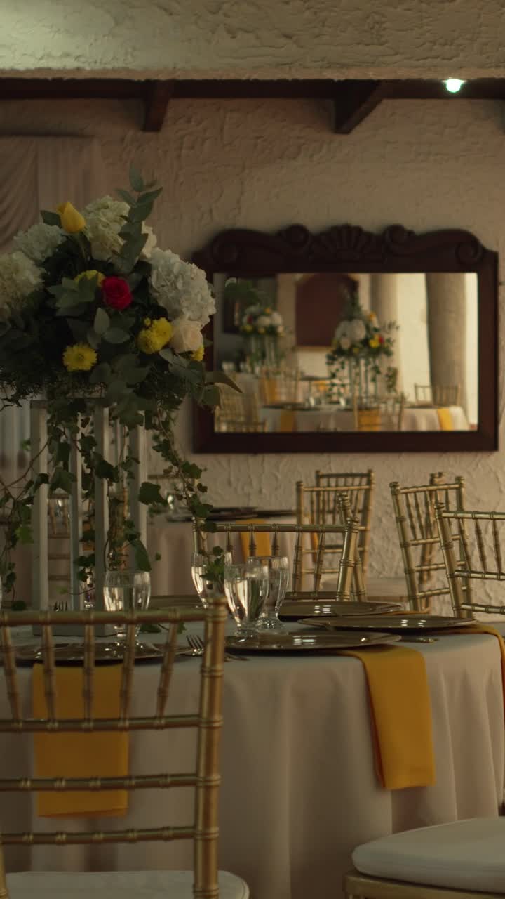 Hall with tables decorated for wedding reception with fresh flowers. Banquet table. Vertical.