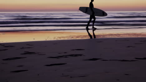 surfer silhouette on the beach at sunset