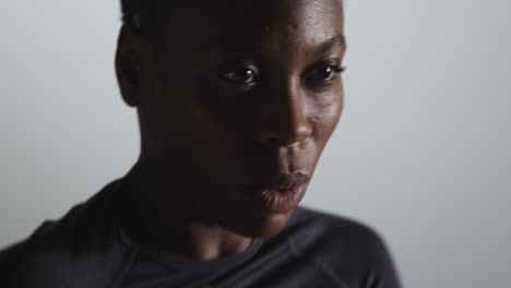 close up studio shot of woman wearing gym fitness clothing exercising running on the spot