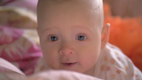 portrait of baby girl with big blue smiling eyes