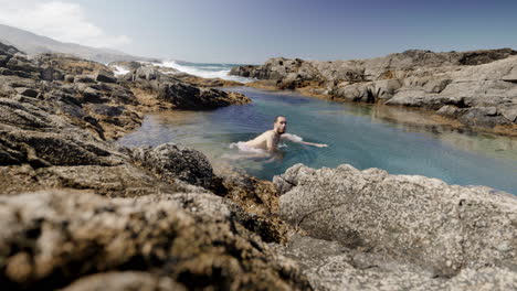 Joven-Varón-Caucásico-En-Traje-De-Baño-Bañándose-Dentro-De-La-Formación-Natural-De-Piscinas-Oceánicas-En-Fuerteventura-Islas-Canarias-España