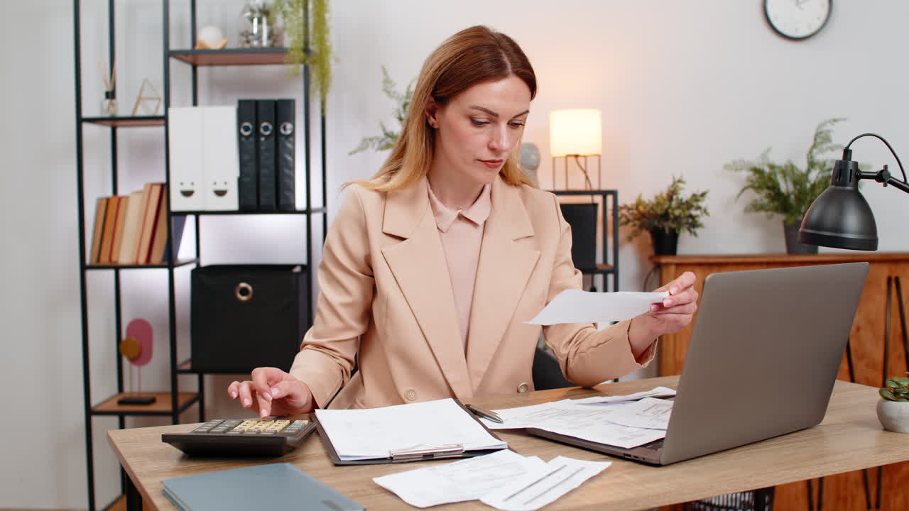 Businesswoman sorts receipts uses calculator balances budget signs final contract with pleased smile
