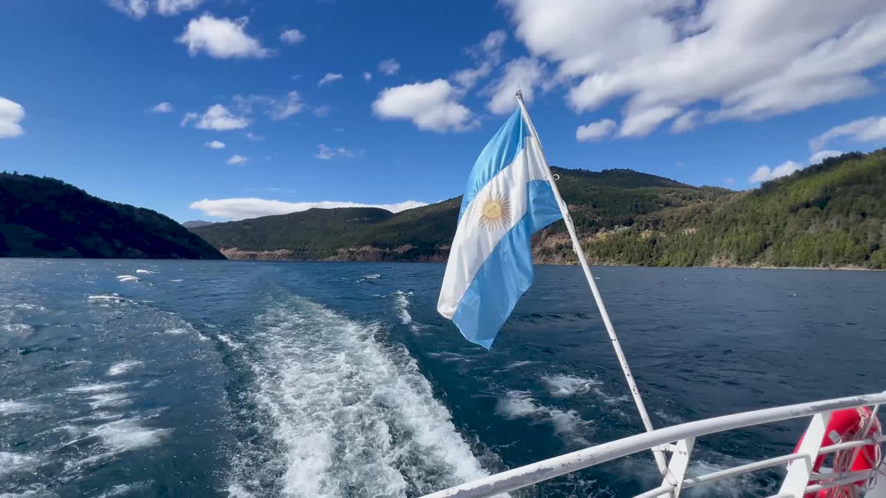 Cruise boat with the Argentine flag in Patagonia, surrounded by clear blue waters