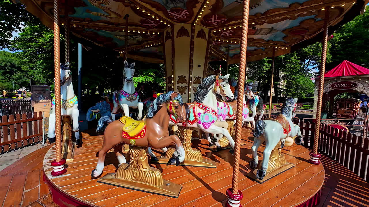 Colourful Merry Go Round Horse Carousel at an Outdoor Fun Park in Slow Motion