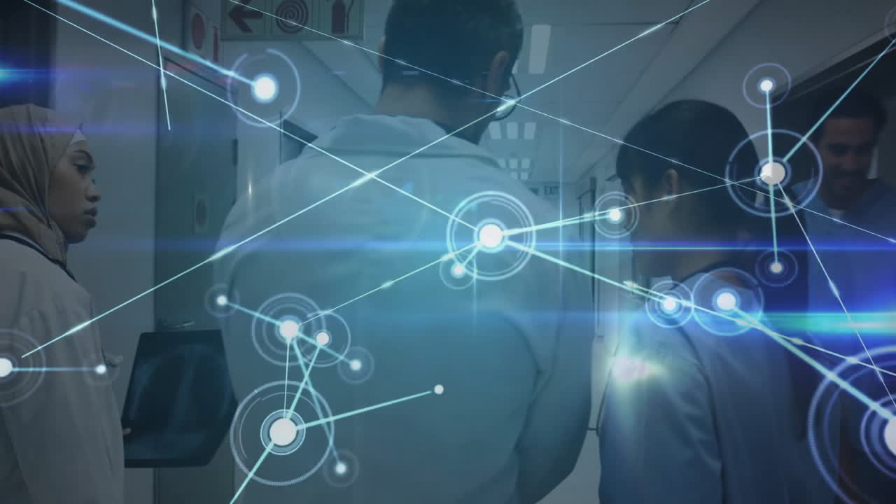 In hospital hallway, healthcare professionals discussing network connections and data processing