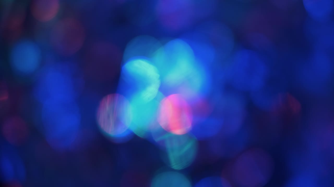 Rotation. Colored shining bokeh lights, sparkling glitter lights. Blurred abstract colorful background.