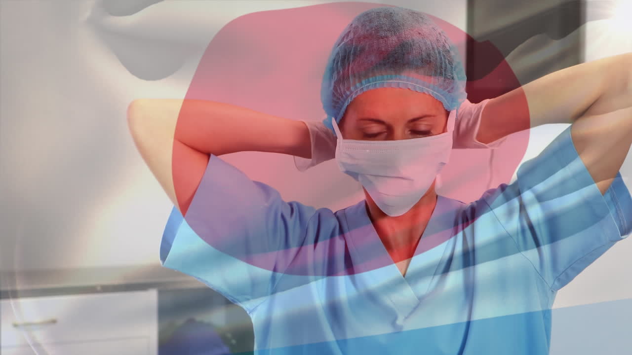 Animation of flag of japan waving over female surgeon in operating theatre