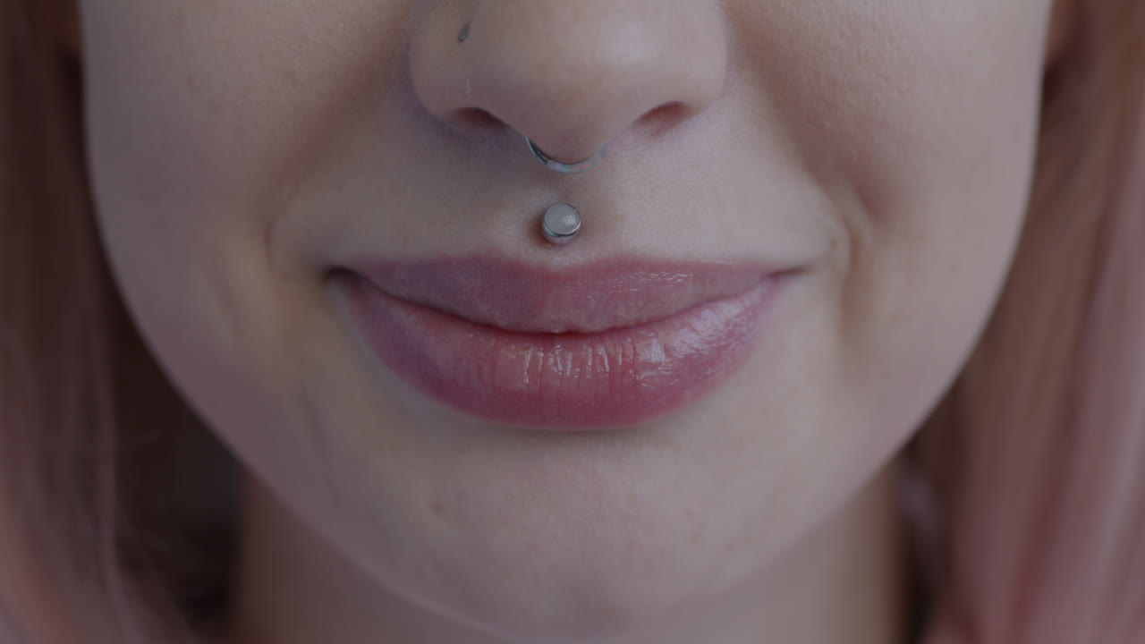 Woman with Nose and Lip Piercings Smiling
