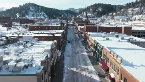 Drone-flying-over-buildings-on-Main-Street-in-Deadwood,-South-Dakota