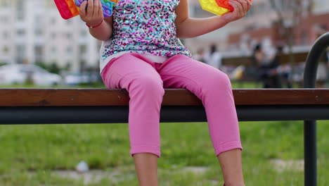 Female-child-girl-playing-push-pop-it-bubble-fidget-stress-anxiety-relief-squeeze-sensory-toy-game