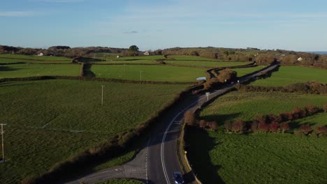 aerial view circling vehicles restriction to 20 miles per hour speed limit in rural farming countryside