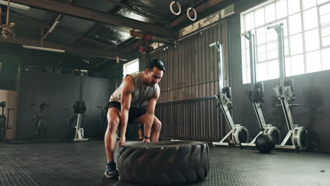 Gym,-man-and-tire-workout-for-strong-muscle