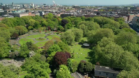 widem reversing aerial video of st stephen's green in dublin city centre, county leinster, ireland, on a bright and sunny day. produced in 4k, 60fps and with rec709 color.