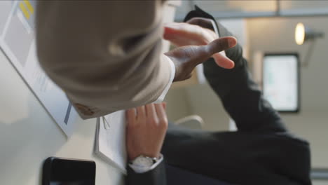 diverse business partners shaking hands at office table