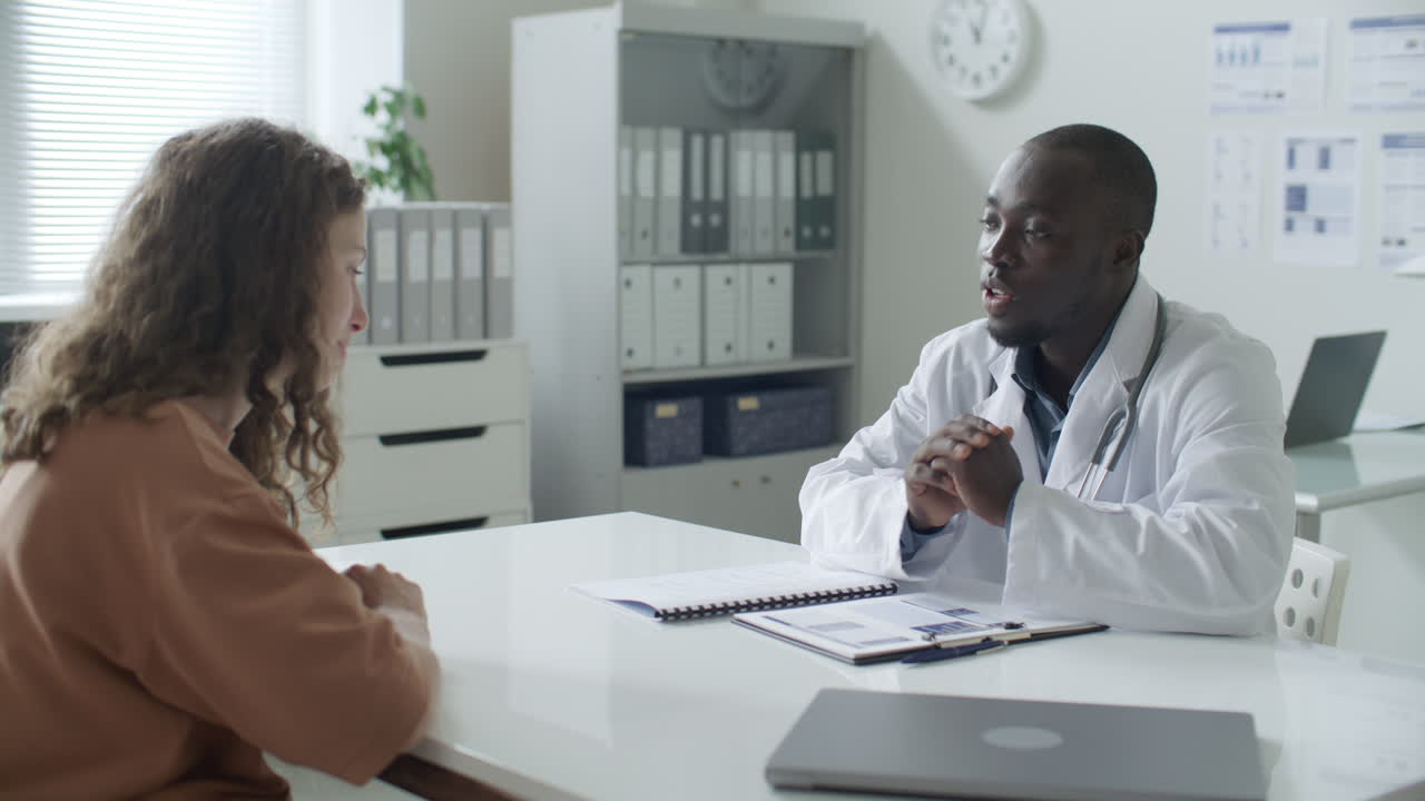 African American Doctor Explaining Diagnosis to Patient in Medical Office
