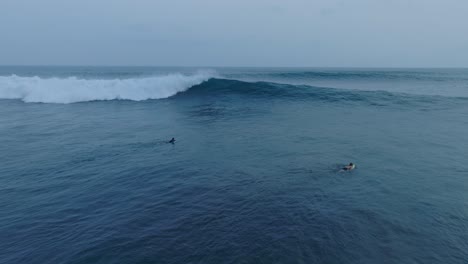 Aerial-Slow-Motion-View-Surfers-At-Sunset-La-Bocana-El-Tunco-El-Salvador