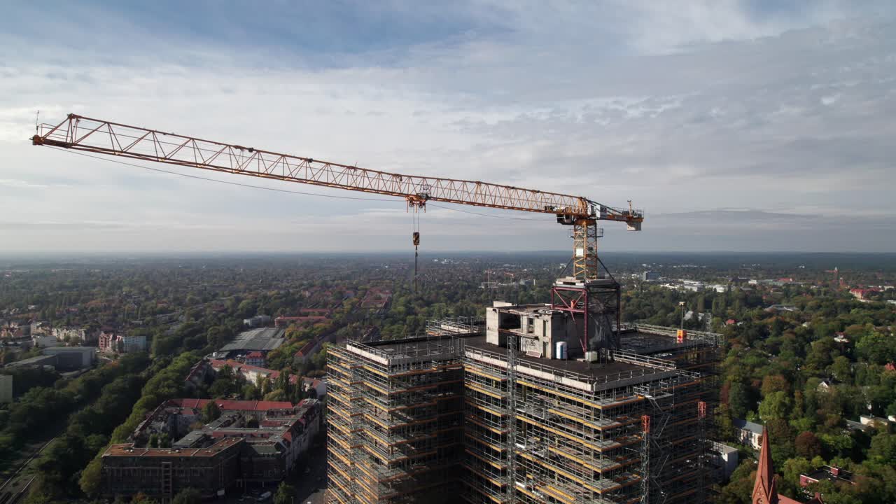 Crane and high-rise construction site in Berlin, Germany, 4K aerial