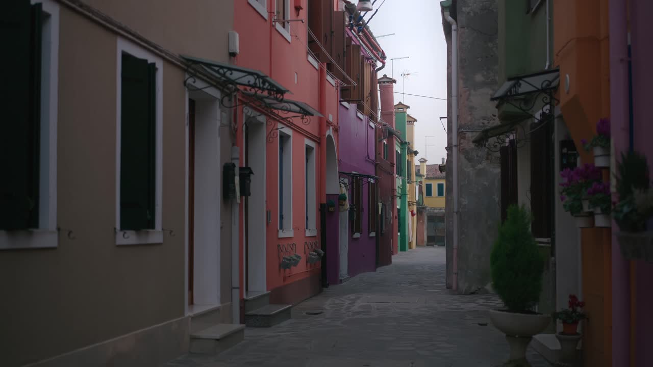 Long shot of narrow street on Burano island, Venice, Italy