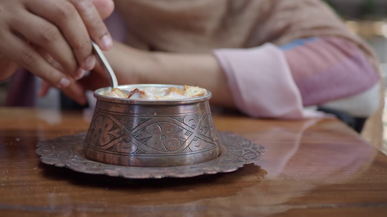 Woman Eating Creamy Soup with Croutons