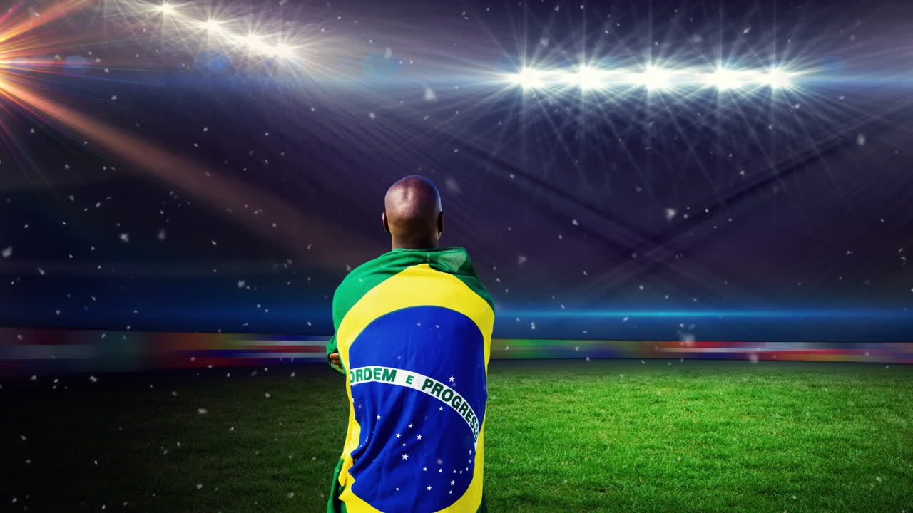 Animazione di polvere che fluttua sulla schiena di un uomo afroamericano con la bandiera brasiliana allo stadio.