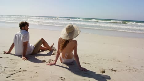 couple relaxing together at beach 4k