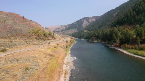 Vehicle-Travelling-On-The-Road-Along-Jackson-Lake-Hot-Springs-In-Wyoming,-USA